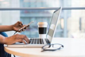Professional working remotely on a laptop, managing tasks in a flexible work setup